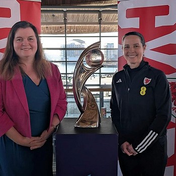 sioned wiliams standing next to the welsh trophy