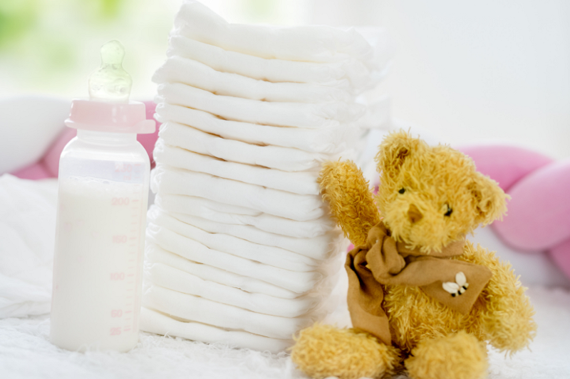 Baby's nappies, bottle and a teddy bear