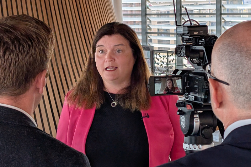 Sioned Williams MS being interviewed by two men with their back to us. Sioned is in front of a camera in the senedd