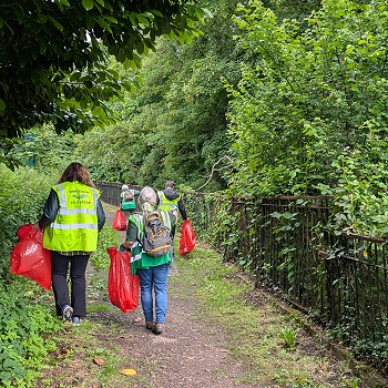 Sioned and a lady picking litter by a canal