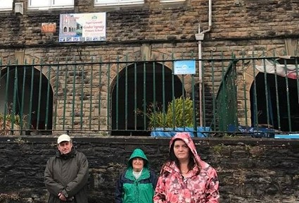 three councillors outside a school