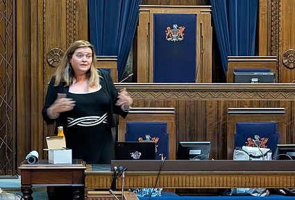 Sioned standing in the Council Chamber, Guildhall, Swansea