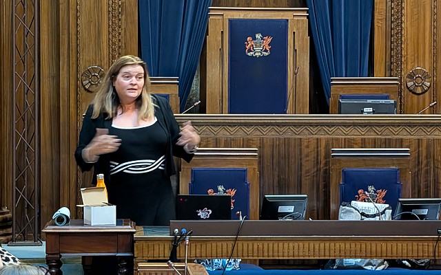 Sioned standing in the Council Chamber, Guildhall, Swansea