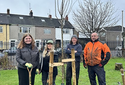 Sioned and volunteers next to a newly planted tree