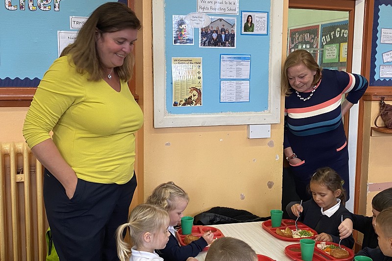 sioned williams looking at students eating their school meals