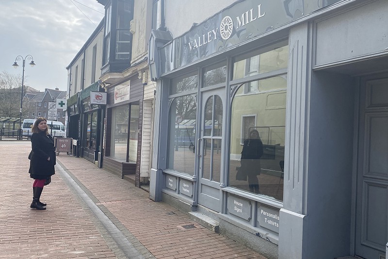 sioned williams standing outside an empty shop in the town centre