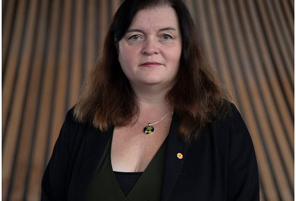 Sioned William MS looking straight in the camera in the Senedd building
