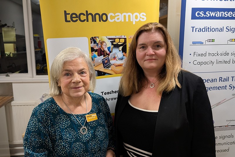 Mae Sioned a Beti Williams MBE yn sefyll o flaen arwydd Technocamps