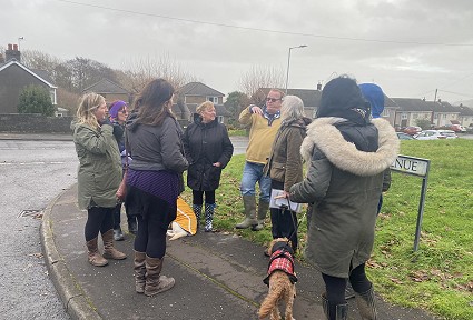 A group of people stood on a street talking